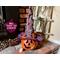 This shows a handmade pumpkin with a tall purple personalized witch hat. It is made using a real dried gourd. The pumpkin's name is Salem.